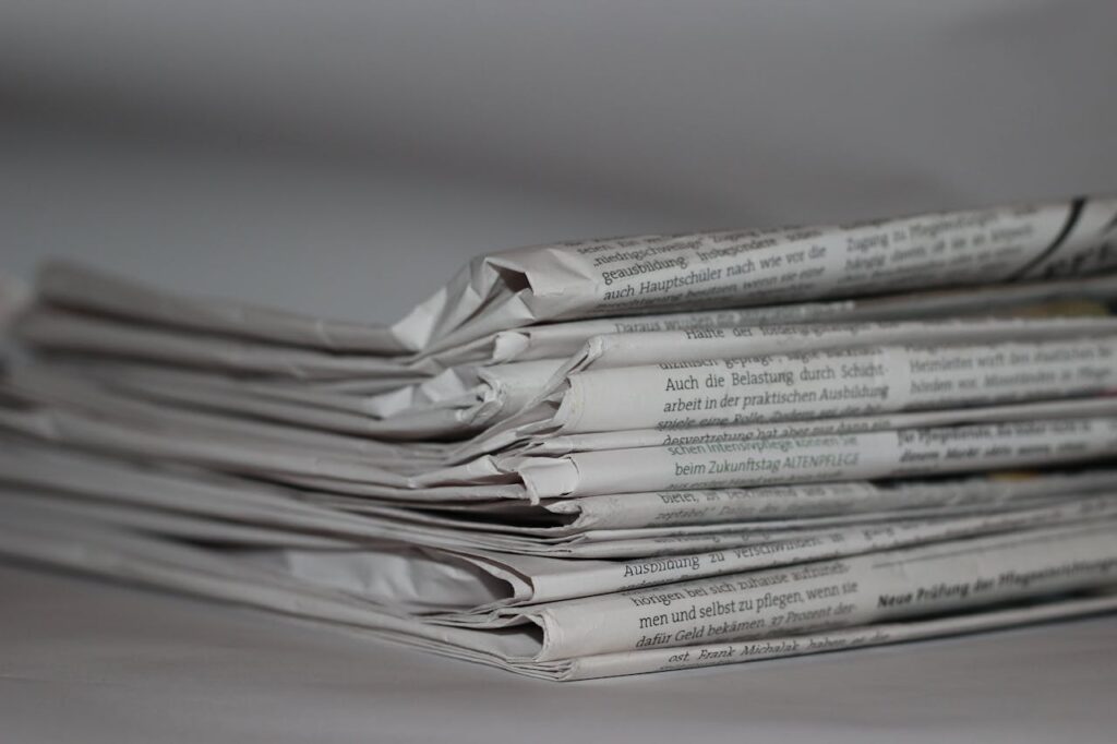 A close-up image of folded newspapers, perfect for news or journalism themes.