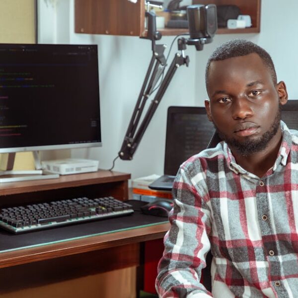 Portrait of a developer coding in a modern office setting, showcasing technology and focus.